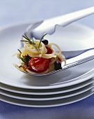 Pasta with tomatoes, black olives and rosemary