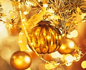 Gold Christmas bauble hanging on the tree
