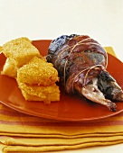 Roast quail wrapped in vine leaf and bacon, polenta slices
