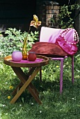 Garden table and pink garden chair with cushion and bag