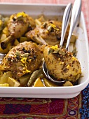 Middle Eastern chicken legs on oven-baked potatoes