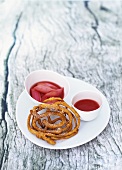 Funnel cake with strawberry puree and rhubarb compote