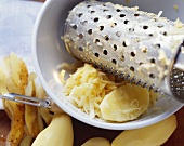 Raw potatoes with grater