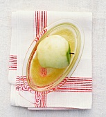 An apple on a grater with apple sauce
