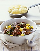 Wild boar ragout with swedes and steamed potato dumplings