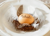 A place setting decorated with a tiny Easter nest