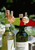 Bottles of white wine decorated with snail shells