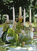 Wine bottles as candle holders decorated with vineleaves