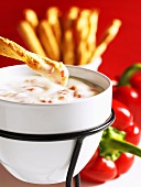 Mozzarella fondue with cheese sticks and peppers