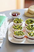 Mini Camembert cheeses with strawberry jam and pistachios