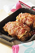 Roast rabbit wrapped in bacon with cranberries