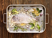 Bream with sea salt and spices in a roasting tin