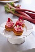 Strawberry muffins with rhubarb stalks in the background