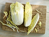 Chinese cabbage on a wooden board, whole and quartered