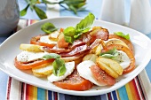 Tomatoes with mozzarella, potatoes and bacon