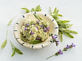 A bowl of sage butter, sage and sage flowers