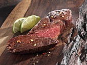 Roasted ostrich fillet on a wooden board
