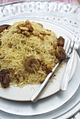 Chicken with noodles, dried figs, dates and almonds (Morocco)