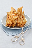 Polish Faworki (deep-fried pastry) with herring