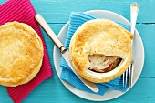 Pork with onions and apples topped with puff pastry
