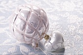 Silver Christmas baubles and a heart decoration