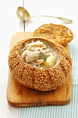 Sauerkraut soup with pork ribs served in hollowed out bread