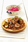 Beef roulade with a mushroom and bacon filling with buckwheat and gherkins