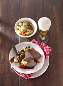 Beef fillet with vegetables, gnocchi and a glass of beer