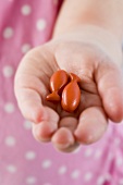 Child's hand holding fish-shaped sweets