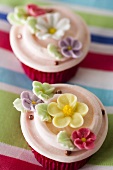 Two cupcakes with sugar flowers