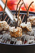 Pork medallions on liquorice skewers on barbecue