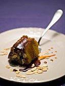 Carrot pudding with caramel sauce and flaked almonds