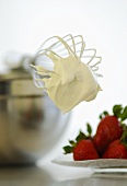 Fresh strawberries with a bowl, whisk, whipped cream