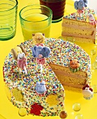 Child's birthday cake with sprinkles and sugar figures