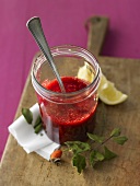 Wild berry sauce in jar with spoon