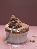 Chocolate soufflé in soufflé dish and on spoon