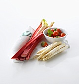 Rhubarb, strawberries and white asparagus on tea towel