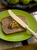 A slice of nut bread with walnuts and dried fruit