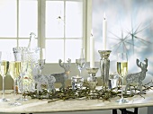 Silver decorations and sparkling wine on a Christmassy table