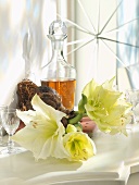 White amaryllis, sherry in crystal decanter