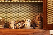Cups in a kitchen cupboard