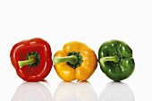 A red, a yellow and a green pepper side by side