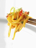 Egg noodles with vegetables on chopsticks (Asia)