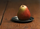 A Forelle pear on a pewter plate