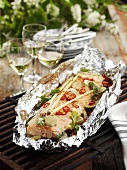 Salmon fillet with lemon grass & chilli in foil on barbecue