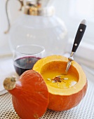 Cream of pumpkin soup with saffron in hollowed-out pumpkin
