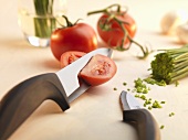 Tomatoes and chives, partly cut