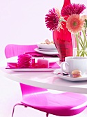 Table laid in pink with coffee and sandwich cookies