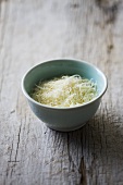 Grated cheese in ceramic bowl
