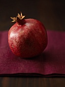 Pomegranate on burgundy red linen cloth